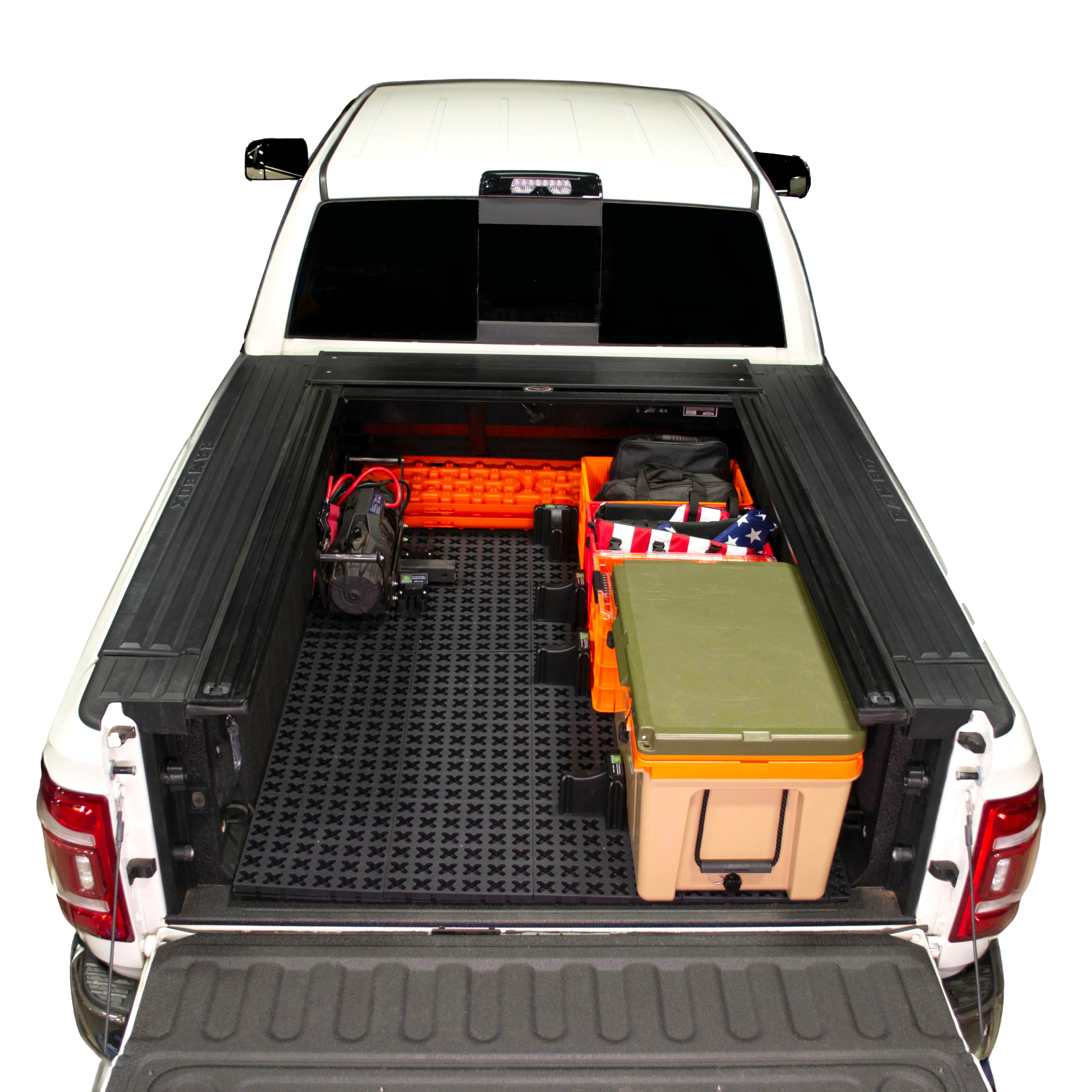 Tmat installed in a Ram 3500 securing a winch, recovery boards, Sidio crates, and a RTIC cooler. 