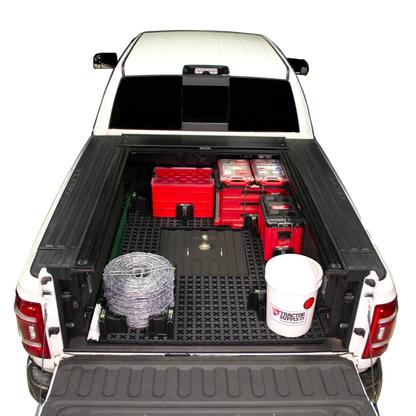 Tmat bed mat around a gooseneck hitch with toolboxes, a bucket, t-posts, and barbed wire.