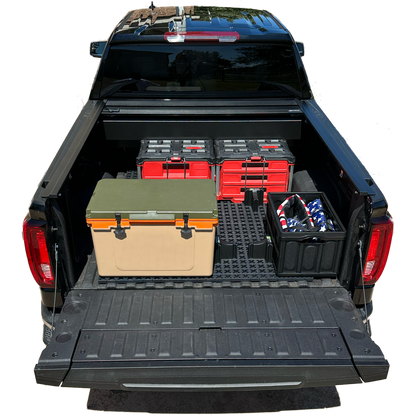 GMC short bed truck with Tmat securing red tool boxes and a brown cooler